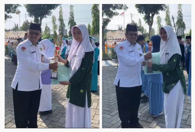 Dua siswa Al Islam Joresan Raih Juara 1 OMI Kabupaten, Terima Penghargaan dari kepala Kemenag Ponorogo.